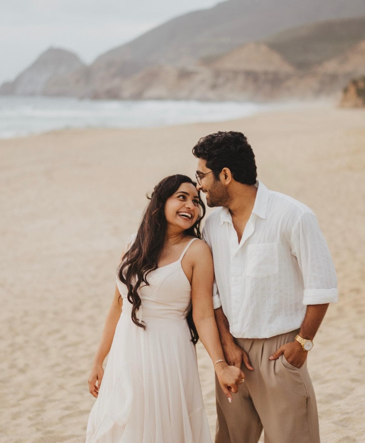 Abhigna and Hemanth standing together on a beach
